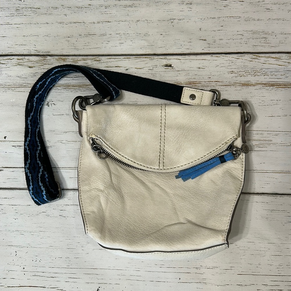The Sak purse with blue clothe strap and fake leather off white bag